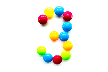 Digit 3 of multicolored rainbow candies isolated on white background. alphabet and numbers