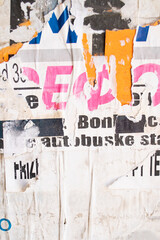 Obraz premium Ripped and torn old street poster background, messy and grungy paper collage backdrop