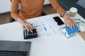 Smart Mortgage Planning woman using a calculator to make Calculations and Consideration
