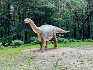 Vulcanodon dinosaur. Realistic figure of the Vulcanodon dinosaur in the forest in Kazimierz, Sosnowiec. The park setting highlights the dinosaur in its natural environment. © Chawran