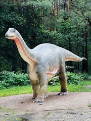 Vulcanodon dinosaur. Realistic figure of the Vulcanodon dinosaur in the forest in Kazimierz, Sosnowiec. The park setting highlights the dinosaur in its natural environment. © Chawran
