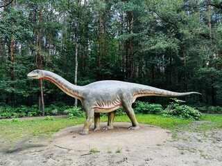 Vulcanodon dinosaur. Realistic figure of the Vulcanodon dinosaur in the forest in Kazimierz, Sosnowiec. The park setting highlights the dinosaur in its natural environment. © Chawran