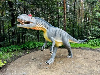 Allosaurus dinosaur. Realistic figure of an Allosaurus dinosaur inforest park in Kazimierz...