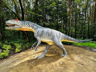 Allosaurus dinosaur. Realistic figure of an Allosaurus dinosaur inforest park in Kazimierz Sosnowiec. Prehistoric predator create a fascinating element of the landscape, attracting dinosaur lovers. © Chawran