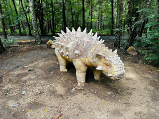 Sajchania dinosaur. Realistic figure of an Sajchania dinosaur inforest park in Kazimierz Sosnowiec. Prehistoric predator create a fascinating element of the landscape, attracting dinosaur lovers. © Chawran
