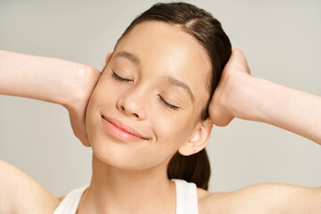 Naklejka premium A stylish, vibrant teenage girl with hands on head in a pose of distress and contemplation.