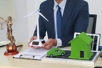 A businessman in a suit sits at a table discussing the Clean Energy Act, which incentivizes...