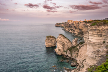 Naklejka premium Early morning sun on the citadel and limestone cliffs of Bonifacio on the Mediterranean island of Corsica
