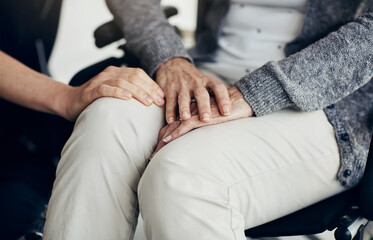 Senior woman, hands and caregiver with help for healthcare, empathy or trust in elderly care or retirement at home. Closeup of people, nurse or touching person with a disability for love at house