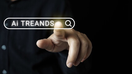 Businessman touching to search engine bar with trends Ai wording for marketing monitor and business planing in new year concept.