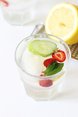 Iced Lemon Flavored Water with Fresh Strawberries, Cucumber Slices and Mint. Morning Refreshing Drinks.