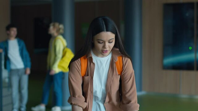 Caucasian student woman female schoolgirl fall books copybooks on floor in school girl drop textbooks clumsy boy guy male teenager help pick up helping friends friendship support love teen education