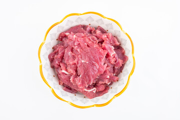 Fresh beef slices on a plate on white background