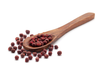 Front view of a wooden spoon filled with dry Organic Lady Finger  (Abelmoschus esculentus) seeds. Isolated on a white background.