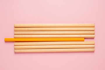 A row of pencils with one of them being yellow