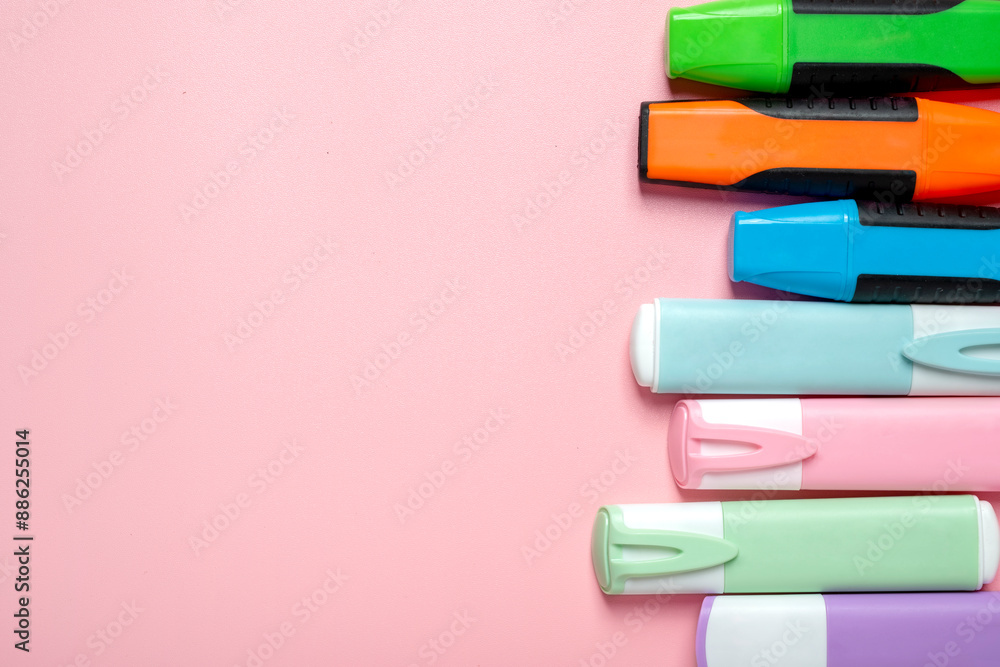 Poster a row of colorful markers on a pink background