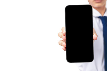 A girl is holding a black phone