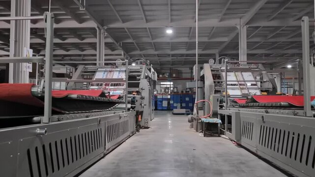 Close up production assembly line Newspapers being folded mechanically on a conveyor belt in a printing press