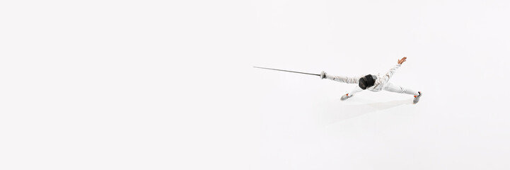 Banner. Aerial view of fencer training in motion his attacking skills against white studio...