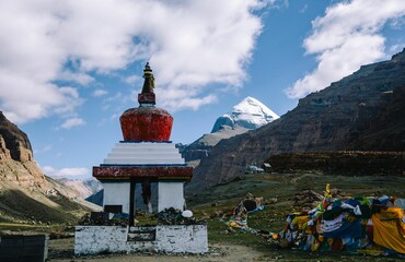 Tibetan Stupa with Prayer Flags and Snow-Capped Mountain © Wirestock