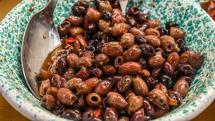 Olives for sale at the market. Fresh olives in a bowl.