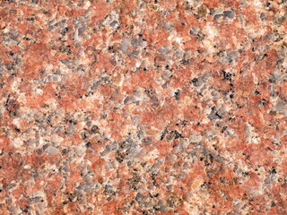 Granite stone texture - Photo of a reddish granite surface of a boulder, suitable for use as a texture or background. The natural stone detail adds a rugged, earthy aesthetic