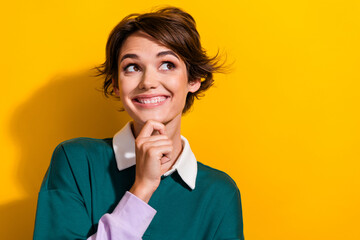 Photo of pretty nice young girl look empty space wonder wear shirt isolated on yellow color...