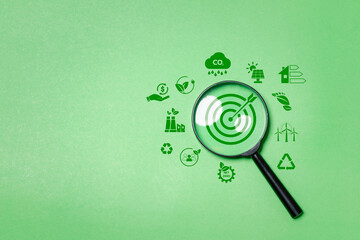 Environment target for green businesses concept, magnifying glass focus to green target icon for...