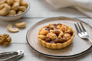 Cake with shortcake dough and nuts. Dessert in a basket with walnut filling, walnuts, hazelnuts and cashews