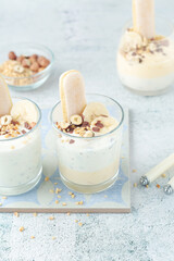 Milk mousse dessert with nuts in glasses	