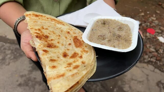 Lachha paratha served with mutton Rezala in India