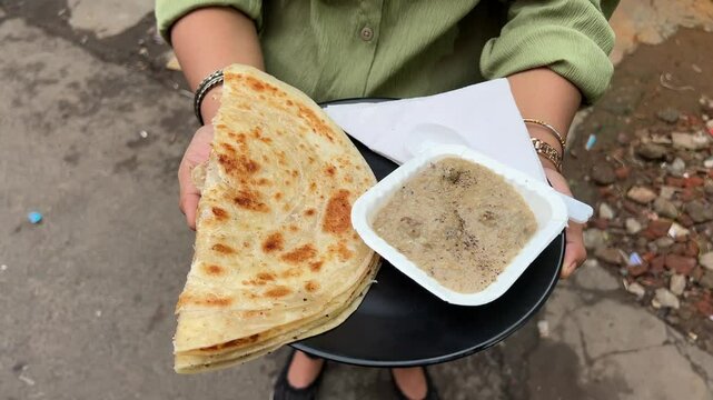 Lachha paratha served with mutton Rezala at a roadside stall in India
