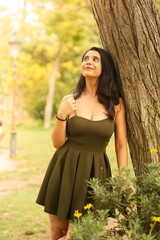 woman relaxing in the park with beautiful smile dreaming dreamy