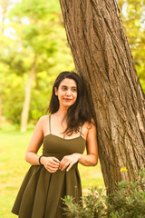 young  woman relaxing in the park with beautiful smile dreaming dreamy