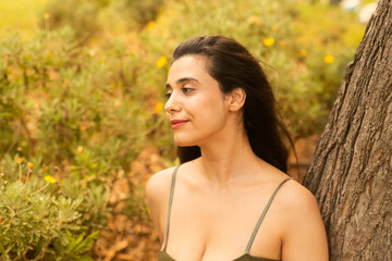 woman relaxing in the park with beautiful smile dreaming dreamy