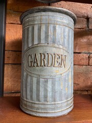 Vintage wooden background with an old tin can and metal barrel