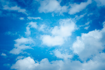 The sky is blue and cloudy. The clouds are white and fluffy. The sky is clear and bright