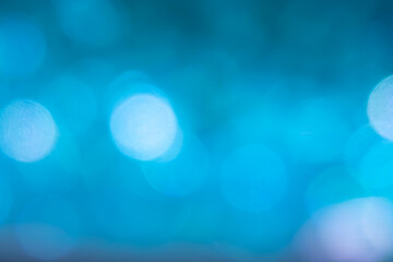 The image is a blue background with a lot of small blue circles. The circles are blurry and overlapping, creating a sense of movement and depth. Scene is calm and serene, with the blue color