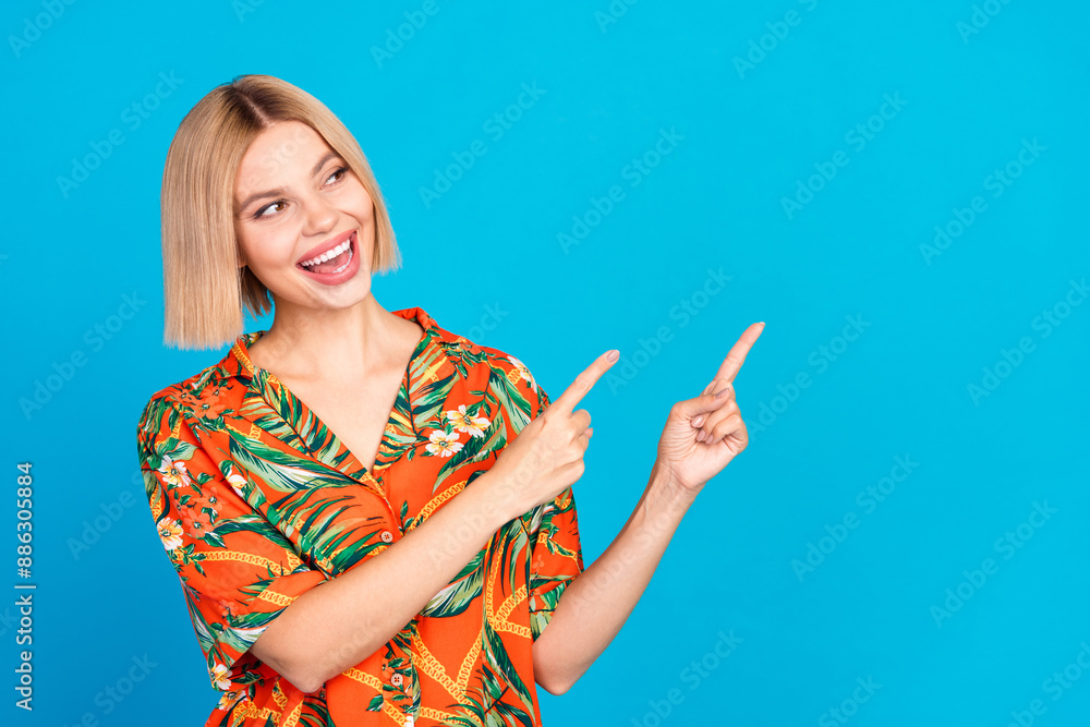 Wall mural photo of funny cheerful nice girl wear trendy print clothes look empty space isolated on blue color 