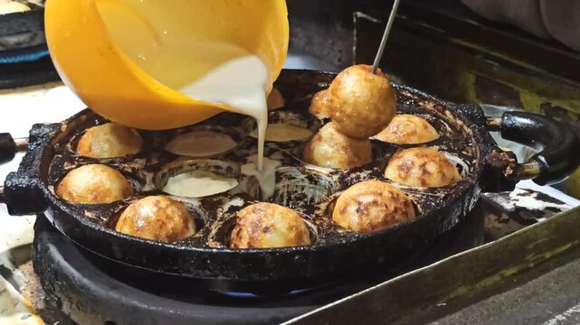indonesian street food: cooking The Takoyaki