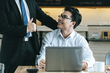 Great job! boss praising the staff employee  in the office after review document and encourages for...