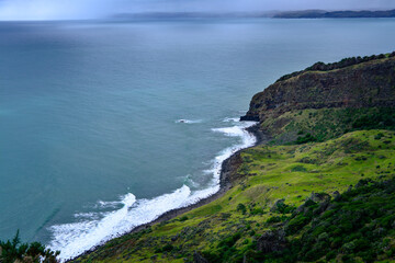 Panoramic view over Te Toto Gorge and Tasman Sea on an overcast summer day. High vantage point. Raglan, New Zealand