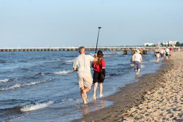 Bloggers are filming a video on the sea coast.
