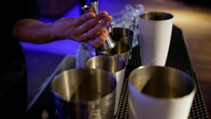 The bartender prepares a delicious cocktail using a shaker, close-up. bartender's hands making cocktails in shakers close-up.