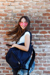 backpack and fashion sunglasses happy in outdoors