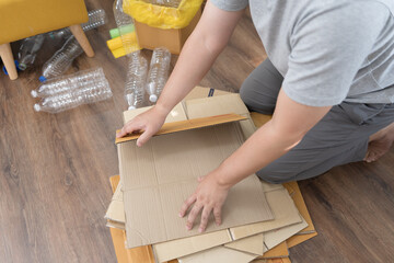 Home recycle eco zero waste concept Man using recycle paper box. Stacking brown cardboard box eco friendly packaging made of recyclable raw materials.