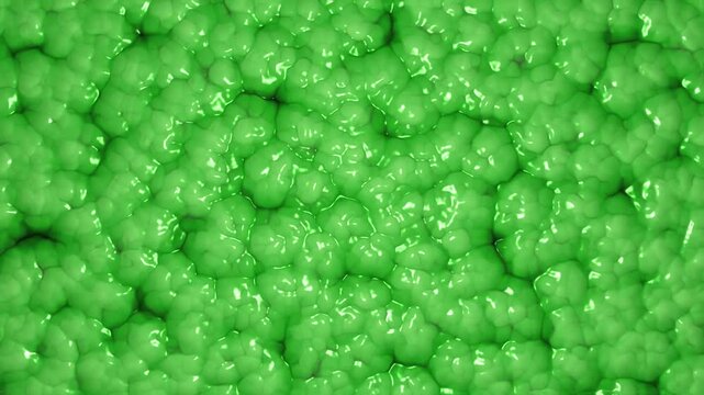 Vibrant oozing green slime abstract background. Microscopic view of an organic cellular structure pattern. Alien organism or texture concept. Full HD and looping motion background.