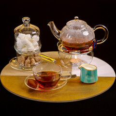 green tea with glass kettle on a black background