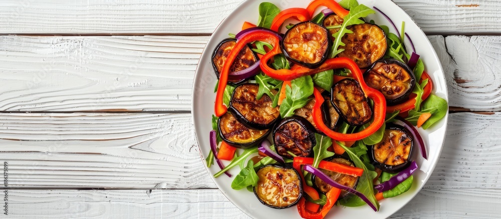 Poster top view of a healthy vegetable salad on a white plate with fried aubergines peppers and carrots set