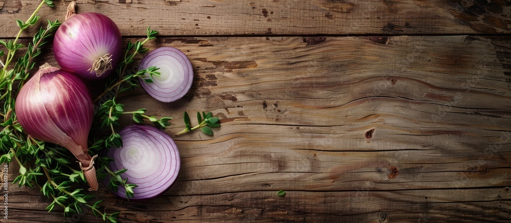 Poster light wooden table with a sliced onion potted herbs and a blank space for an image. copy space avail